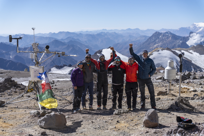 meteorologists celebrate weather station installation on mountain top