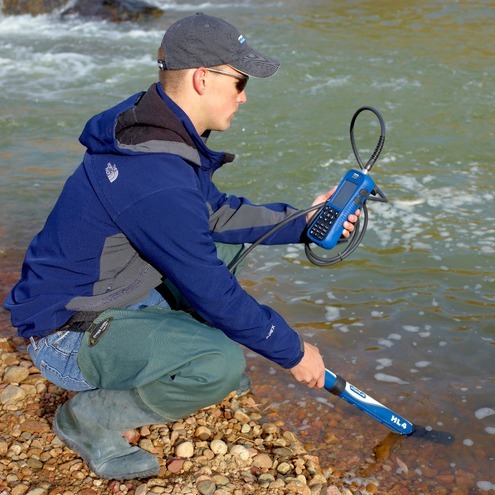 hydrologist measuring strea conditions with a water quality sonde